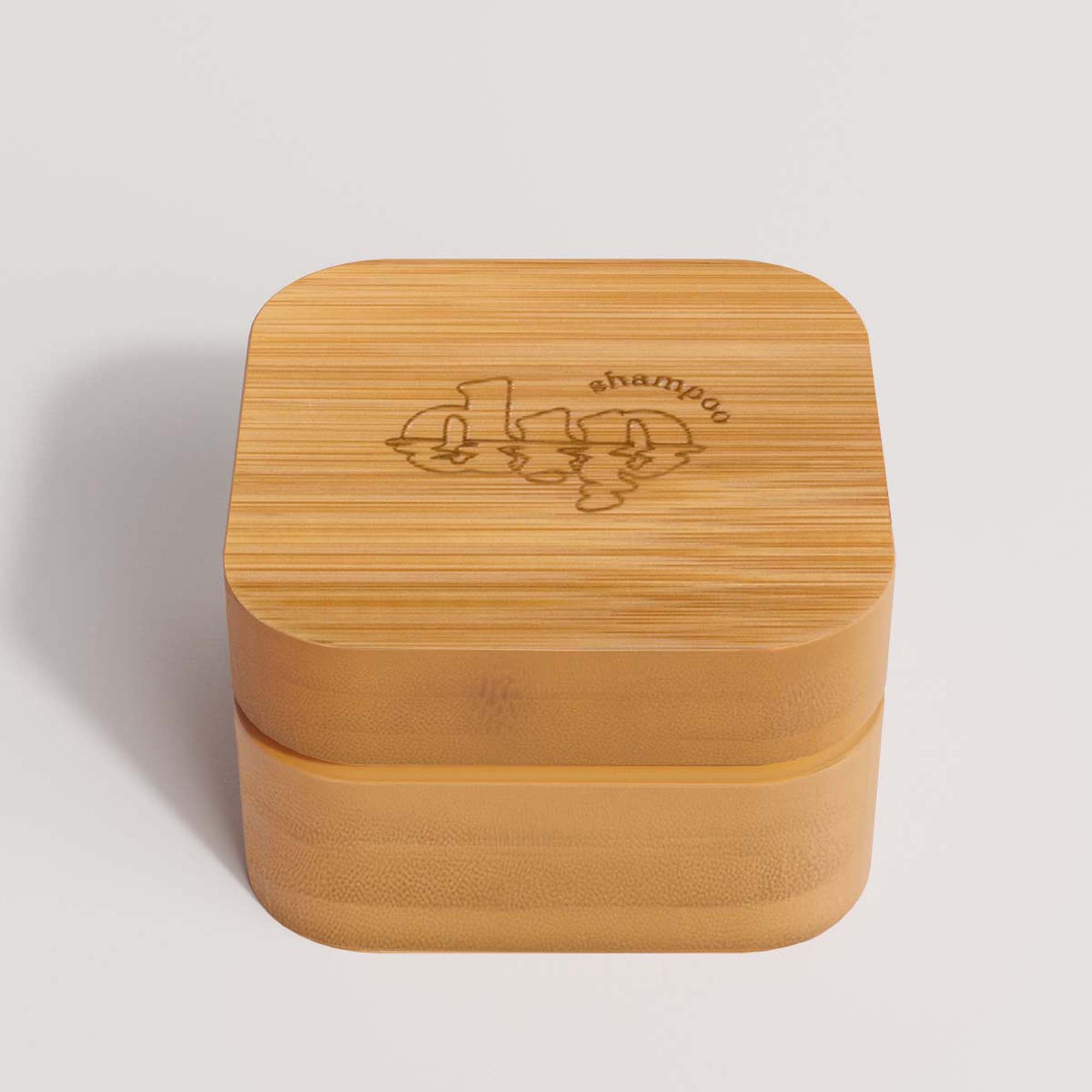 Bamboo container with engraved text on a light gray background