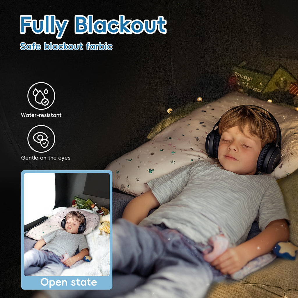 Child sleeping with headphones on, surrounded by a dark room with blackout fabric.
