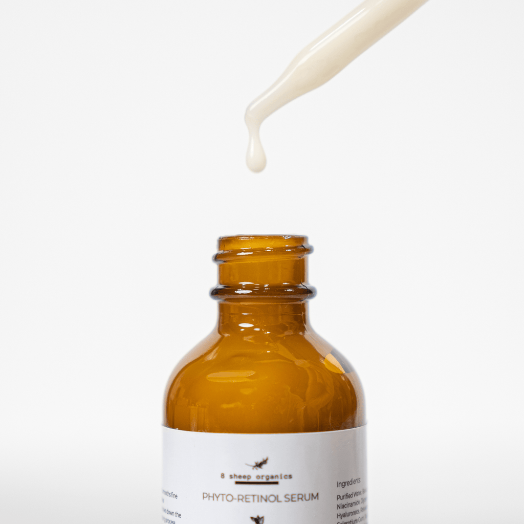 Amber glass bottle of phyto-retinol serum with a dropper on a white background