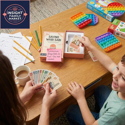 Child and adult playing an educational card game with sensory toys and math worksheet on table.