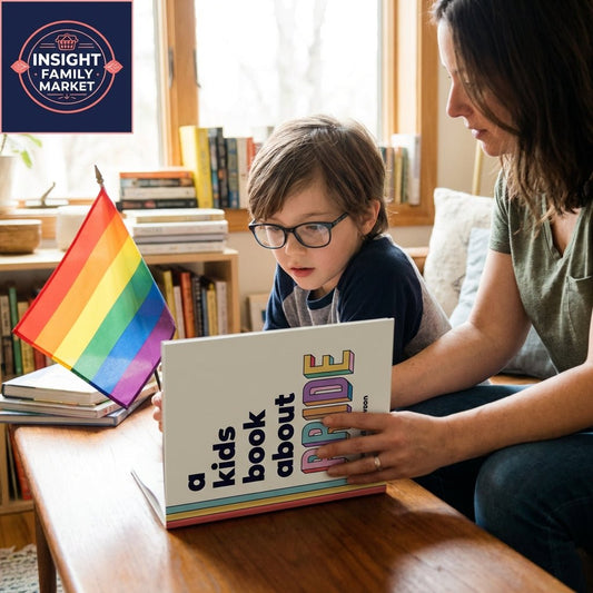Child and adult reading a kids' book about Pride with a rainbow flag in a cozy home setting.