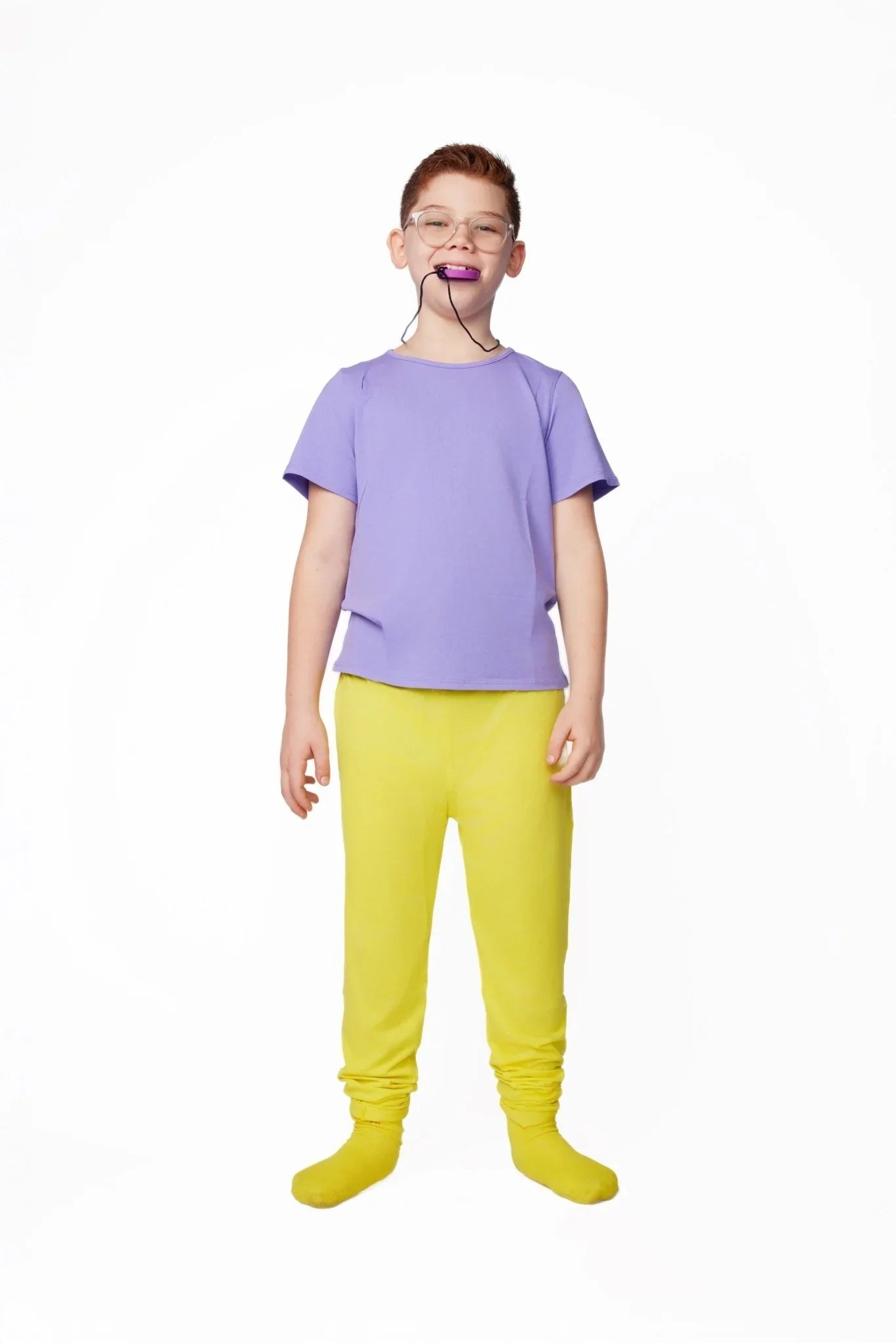 Child in sensory-friendly purple shirt and yellow pants with chewable necklace