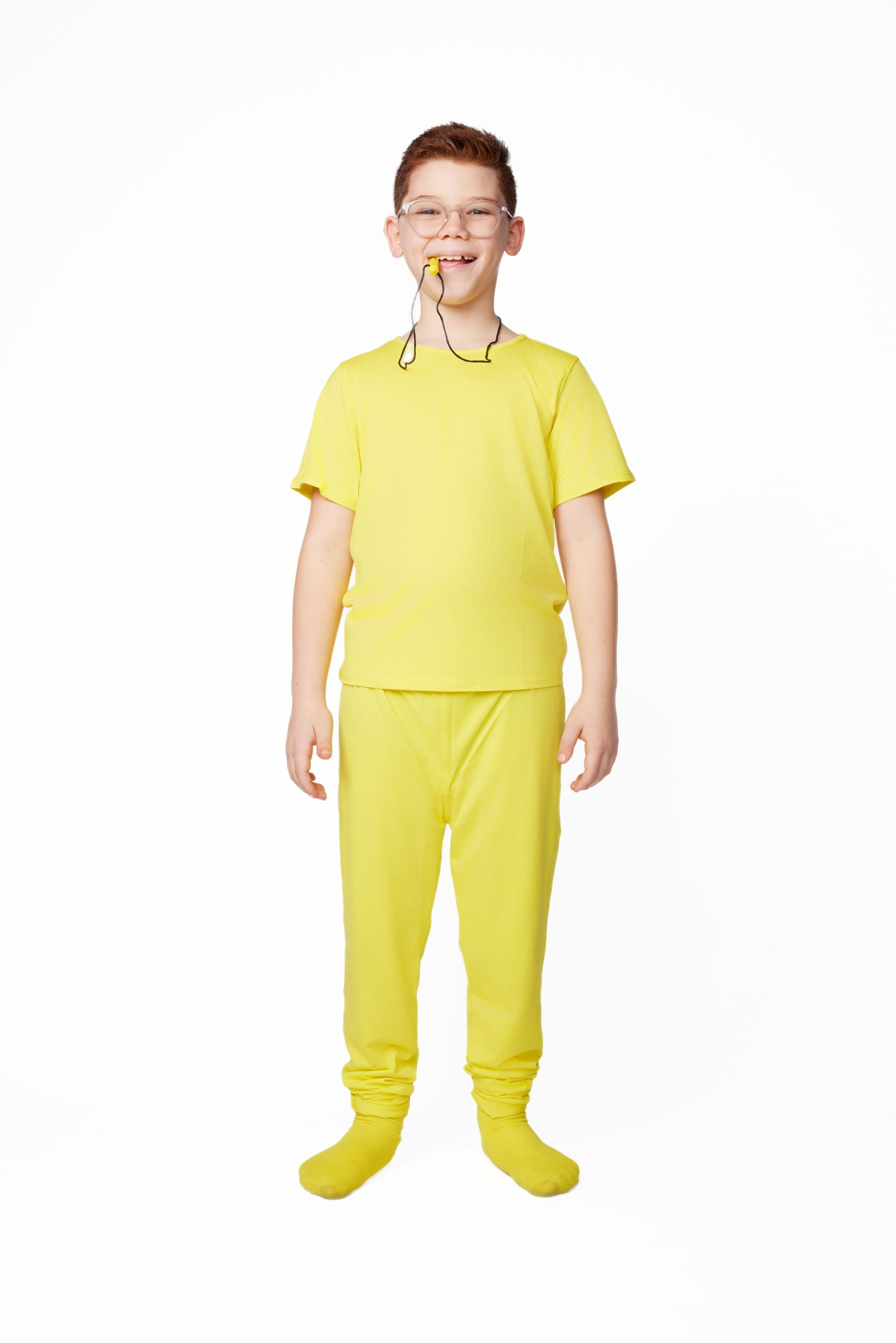Child wearing a bright yellow outfit with a white background
