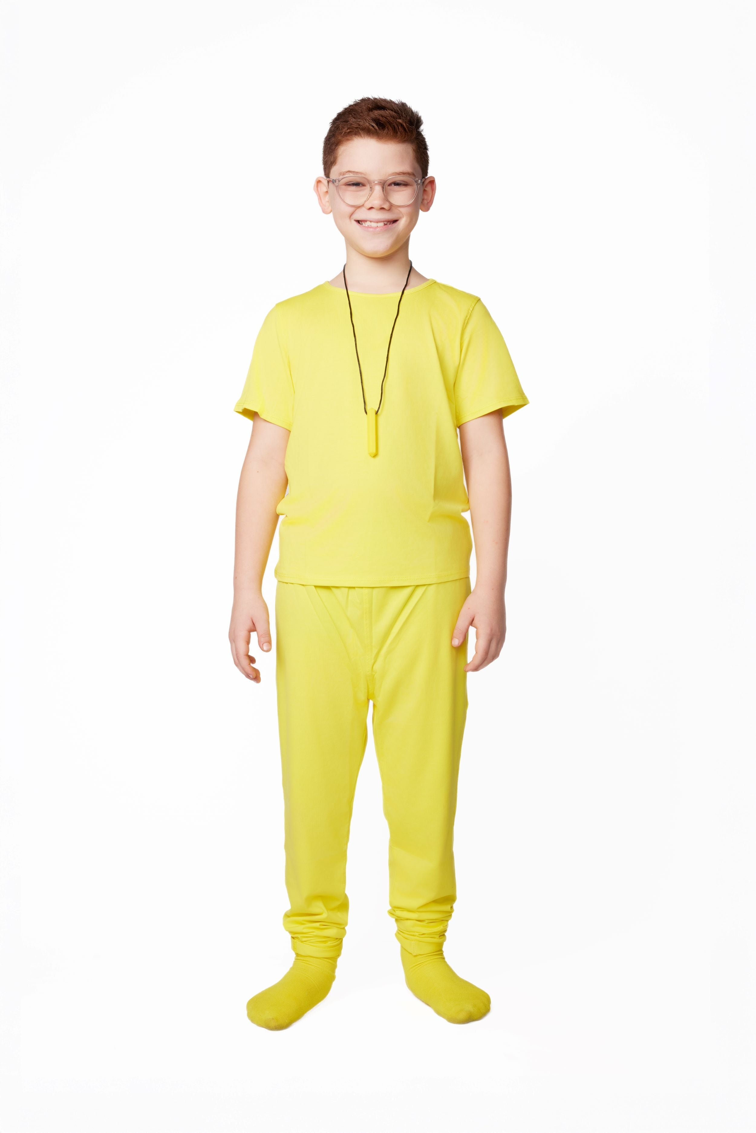 Child wearing a bright yellow outfit on a white background