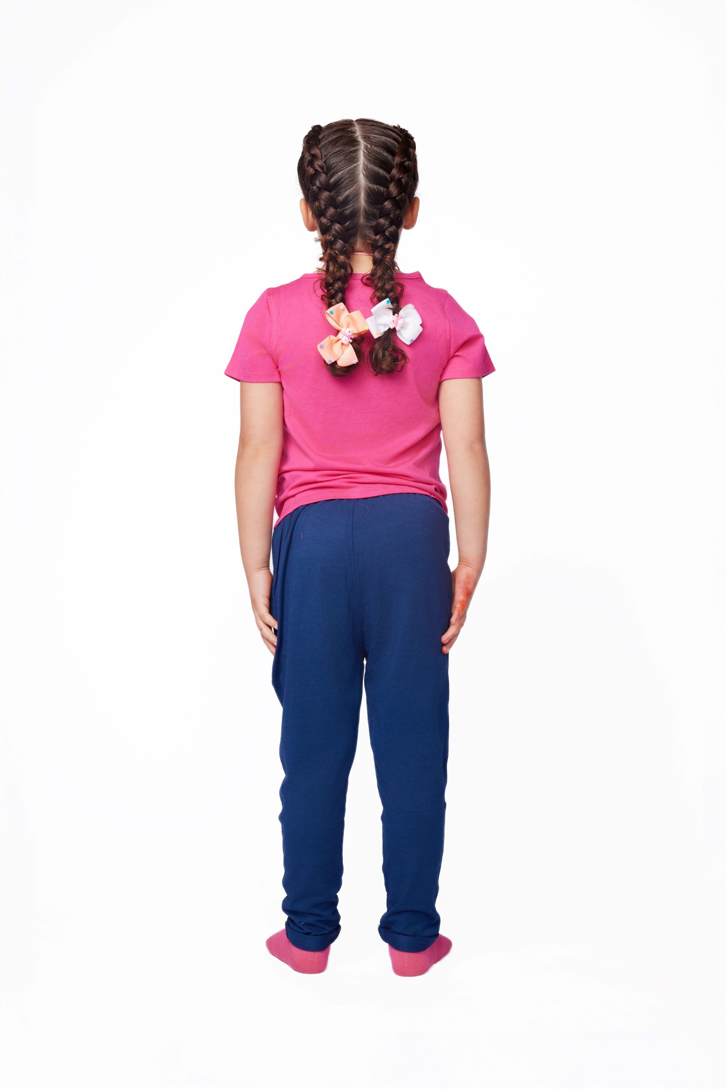 Girl wearing a pink shirt and blue pants on a white background