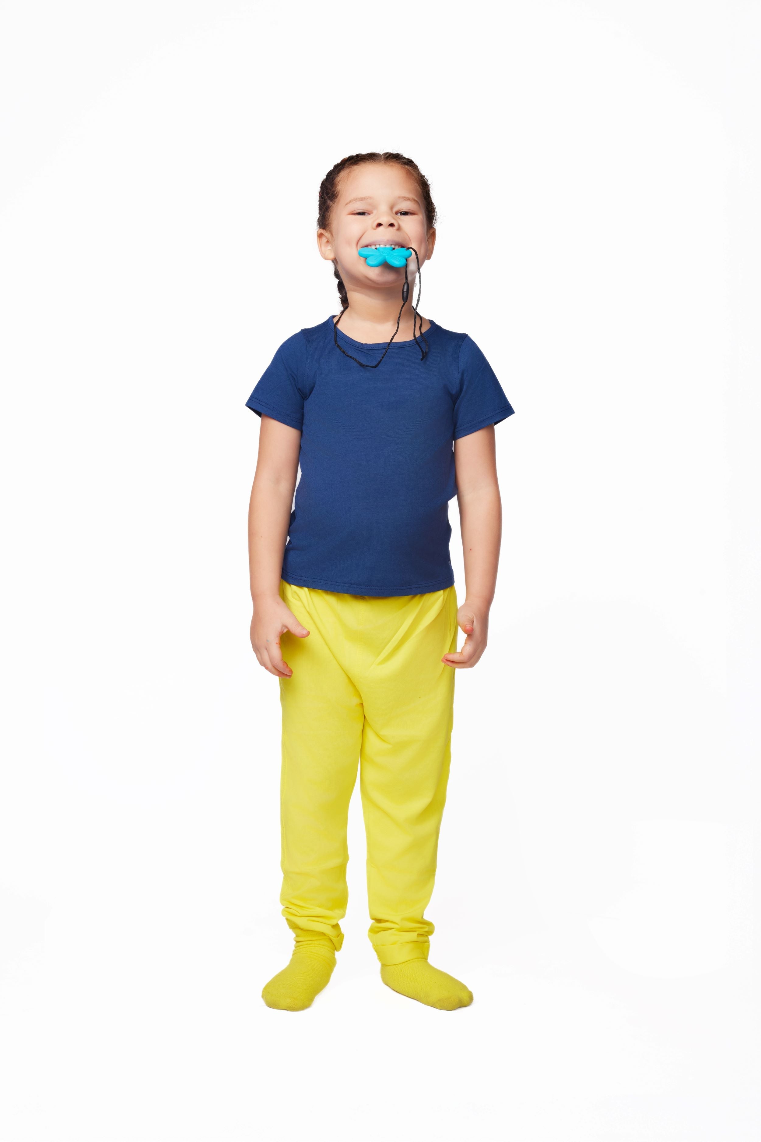 Child wearing a blue shirt and yellow pants on a white background