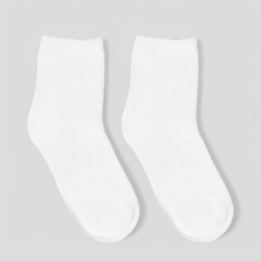 Pair of plain white sensory-friendly socks on a neutral background