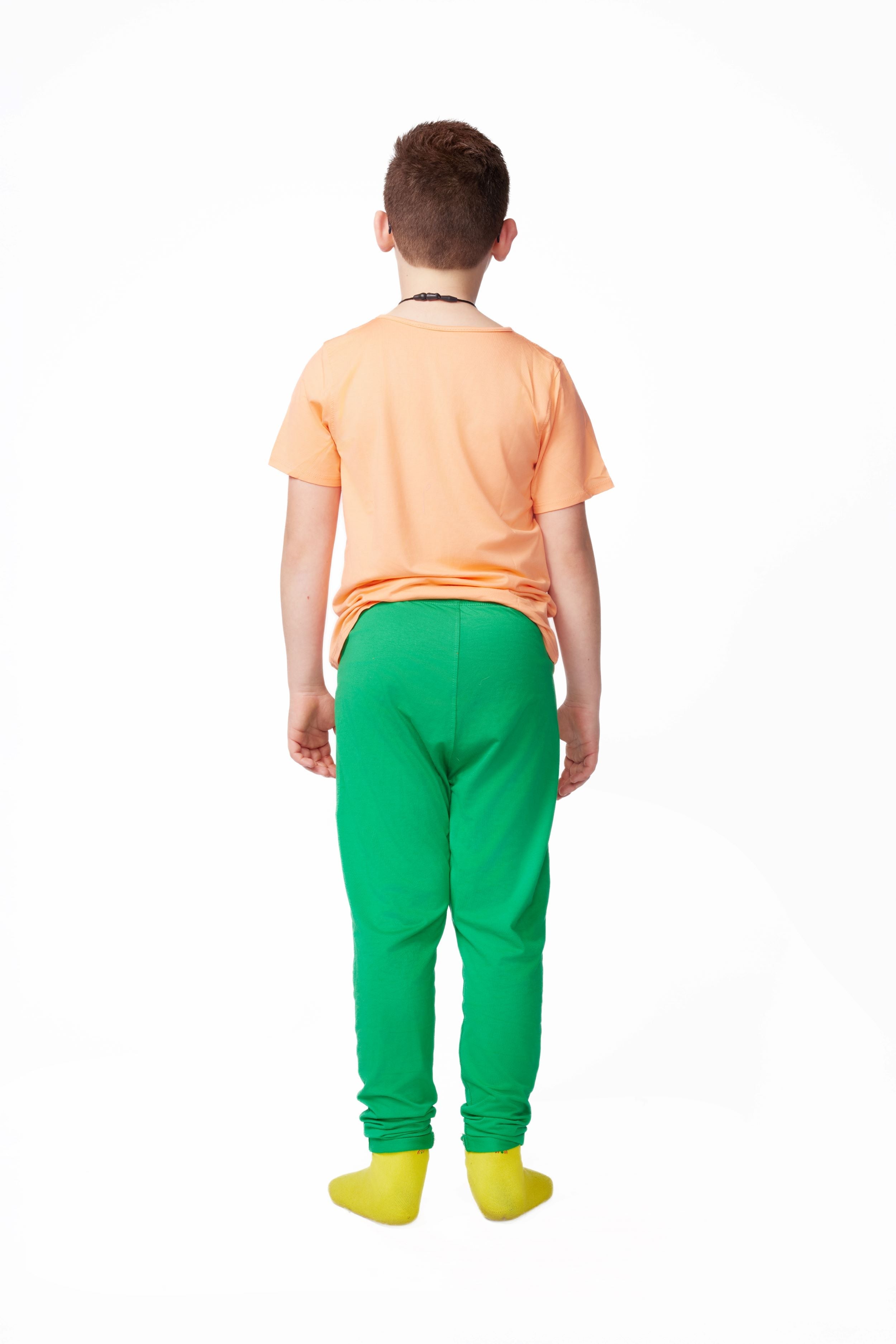 Person wearing an orange shirt and green pants on a white background