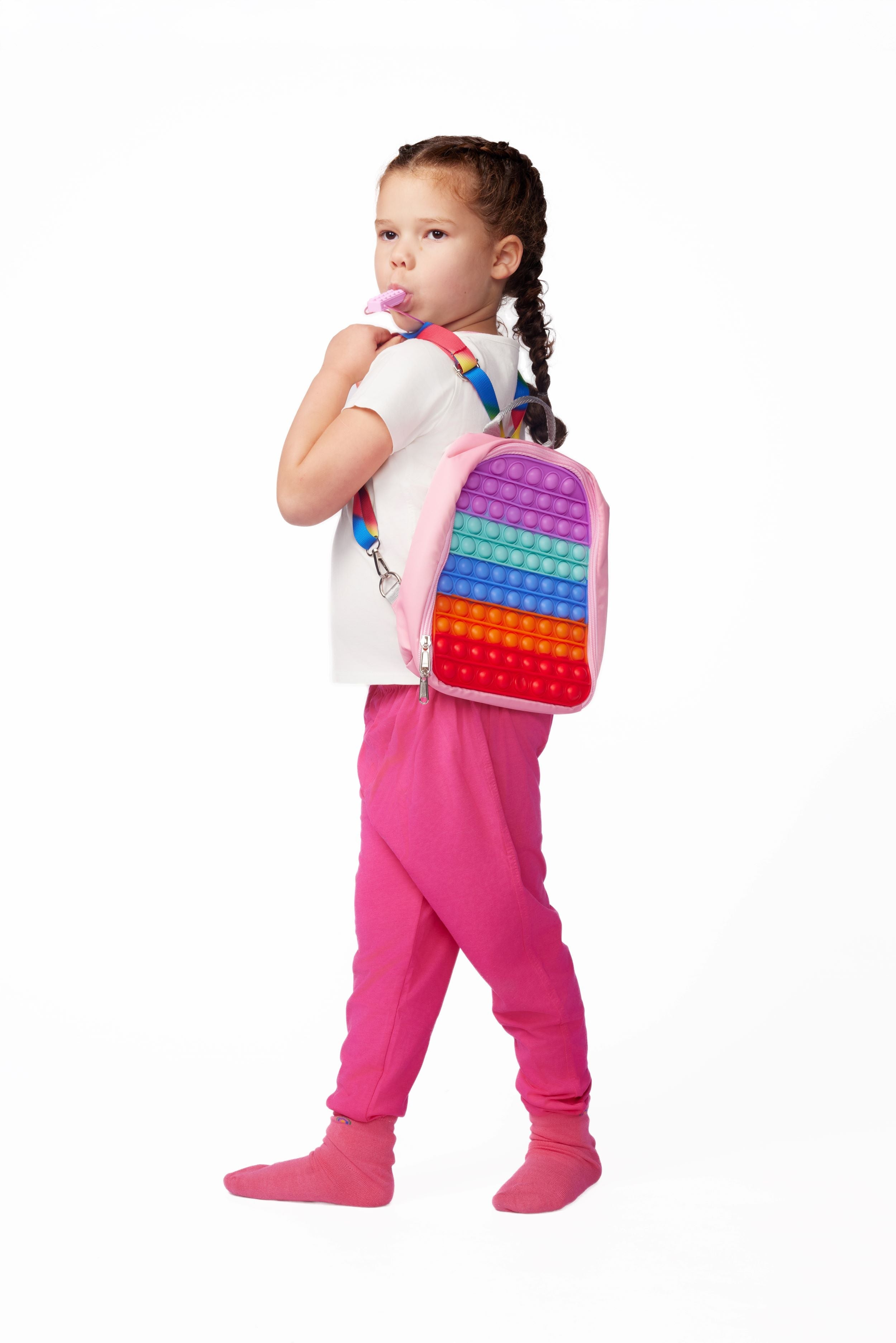 Child wearing a colorful backpack with a pop-it fidget toy on a white background