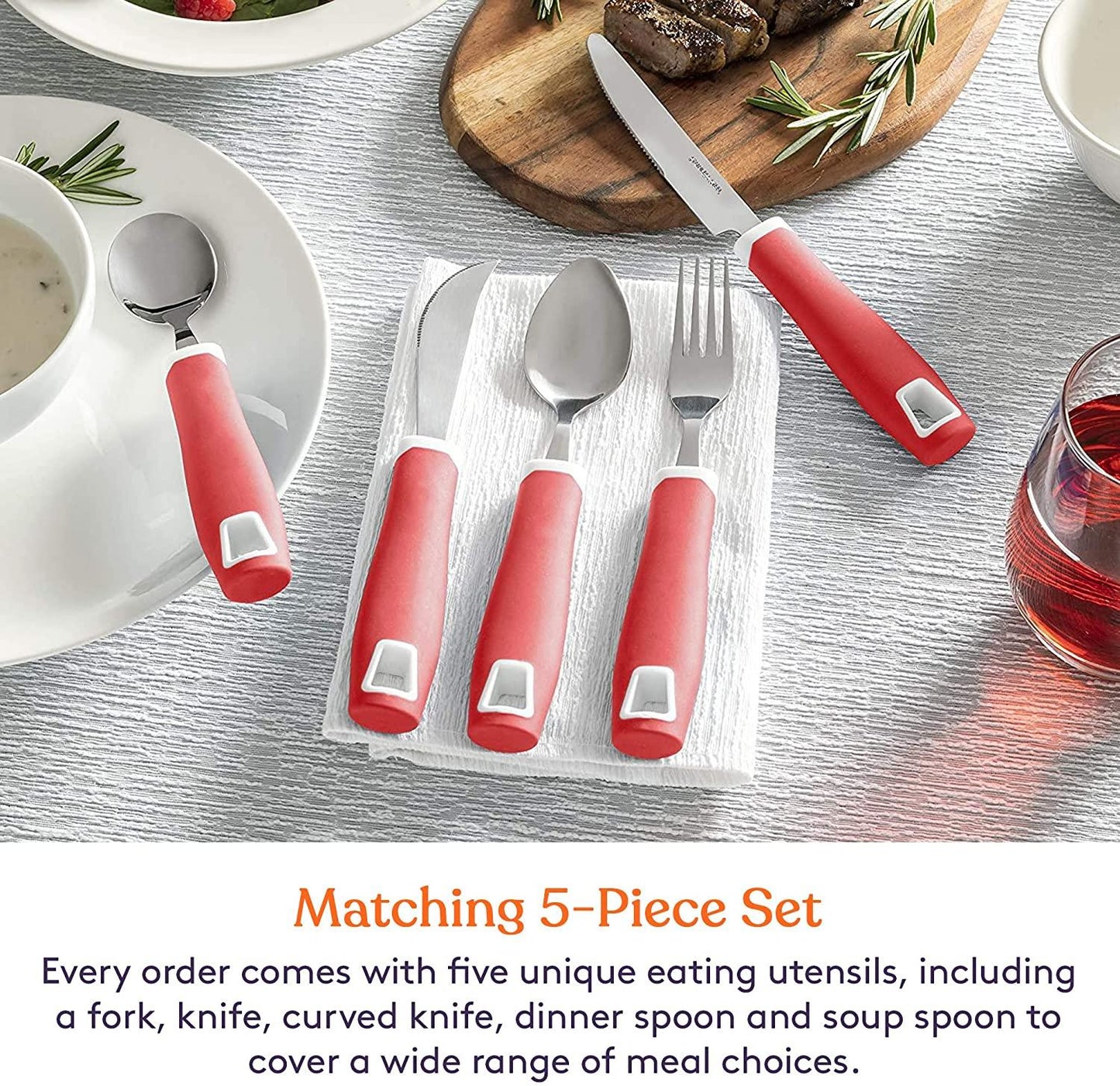 Adaptive red handle 5-piece utensil set with fork, knives, spoons on dining table.