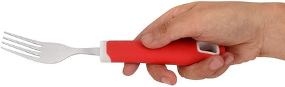 Adaptive fork with large red ergonomic handle held by a hand for sensory-friendly eating