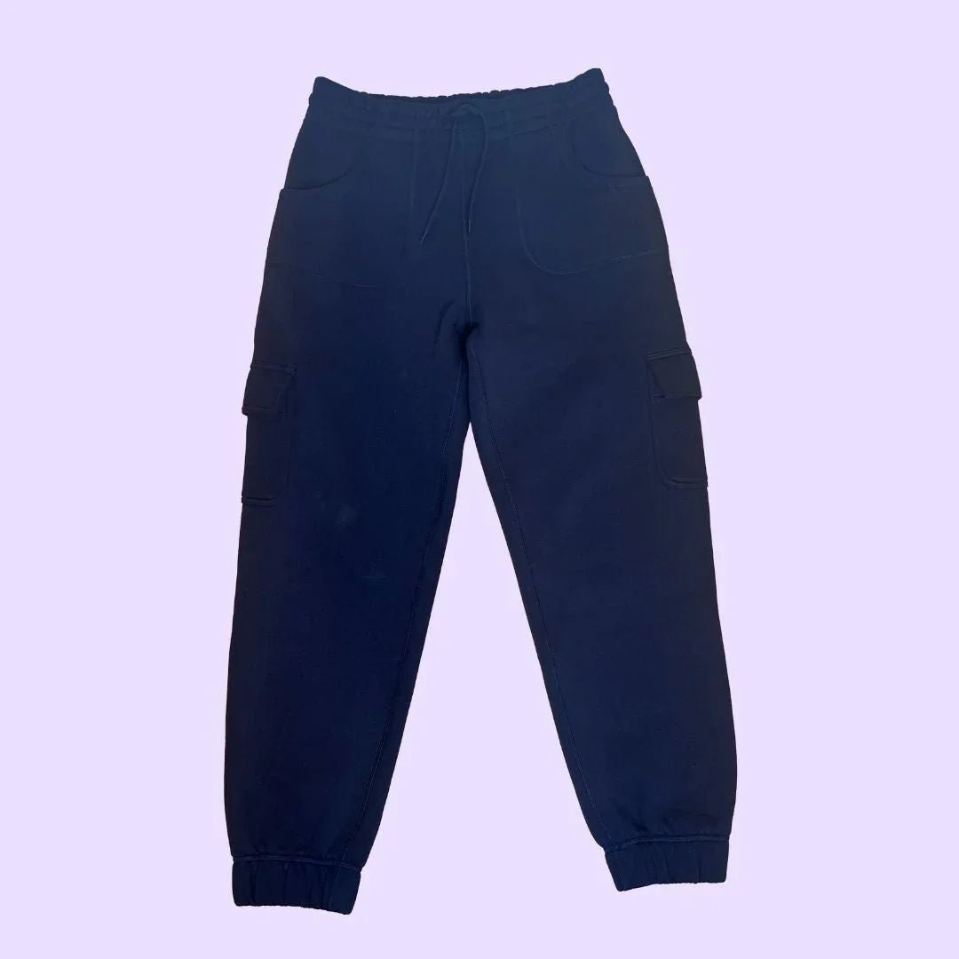 Navy blue sensory-friendly jogger pants with cargo pockets on light purple background