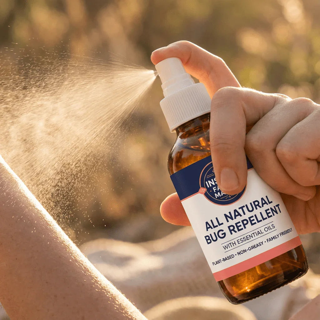 Spray bottle of all natural bug repellent with essential oils applied to skin outdoors