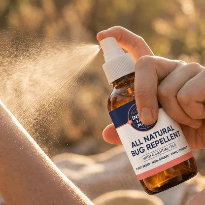 Spray bottle of all natural bug repellent with essential oils applied to skin outdoors