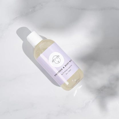 9 Sheep Organics shampoo and body wash bottle with light purple label on white marble surface