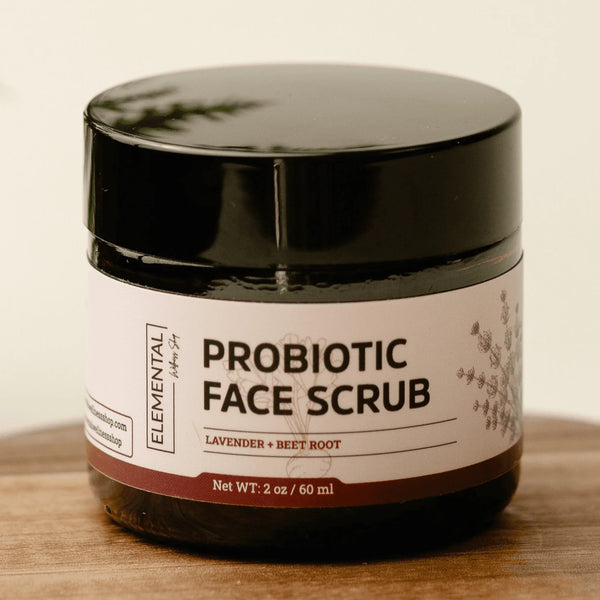 Probiotic face scrub jar with lavender and beet root on wooden surface, natural skincare product