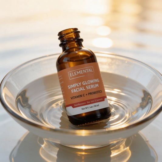 Vitamin C probiotic facial serum bottle in glass bowl with water and golden sunlight