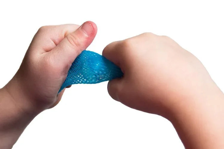 Child's hands squeezing blue sensory fidget mesh tube against white background