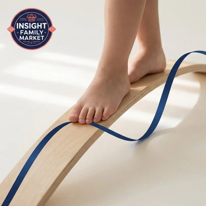 Child balancing barefoot on wooden sensory balance board with blue ribbon for motor skills