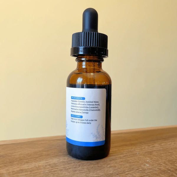 Amber glass dropper bottle of Chill Out liquid herbal tincture on a clean, solid background.
