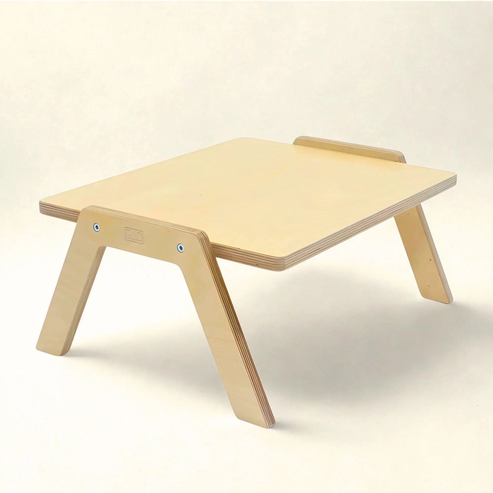 Wooden sensory-friendly low chowki table with angled legs, ideal for flexible learning spaces
