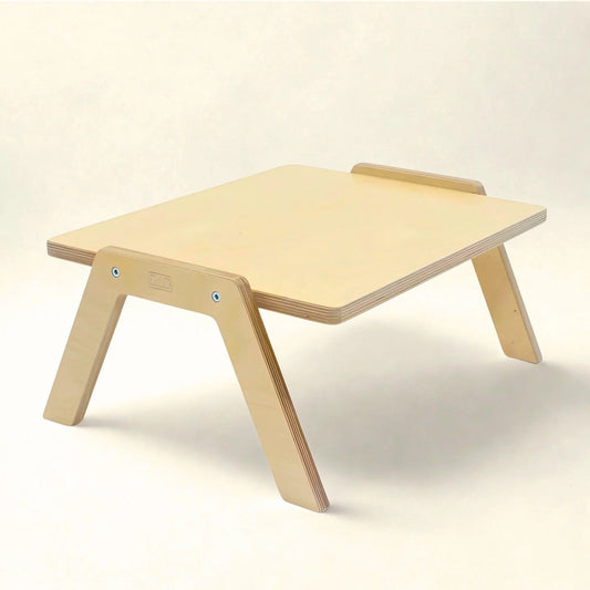 Wooden sensory-friendly low chowki table with angled legs, ideal for flexible learning spaces