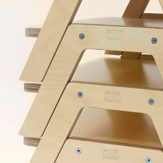 Stacked wooden chowki tables with smooth edges and visible hardware