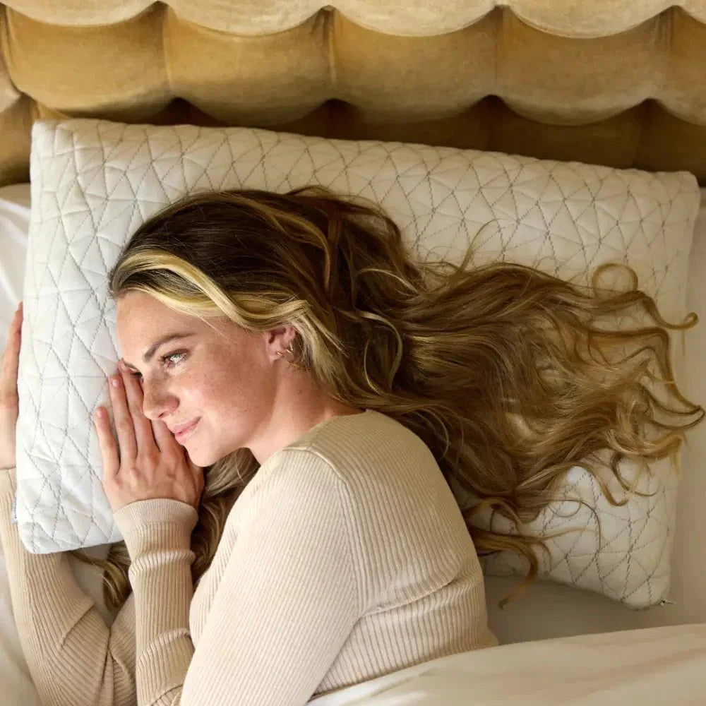 Woman lying on a quilted sensory-friendly pillow in bed, supporting restful sleep