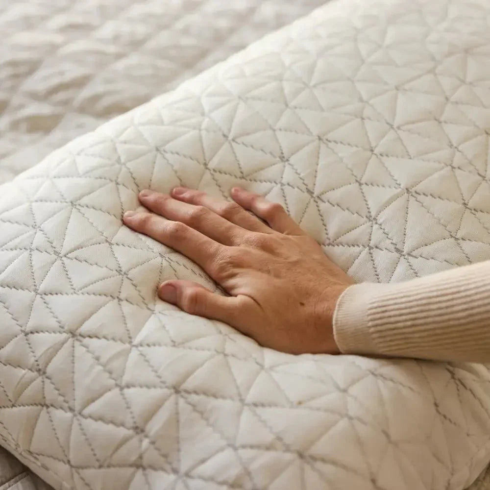 Hand pressing soft quilted pillow with geometric stitching for sensory sleep support