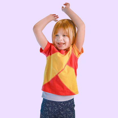 Child wearing a red and yellow sensory compression shirt for sensory-friendly support