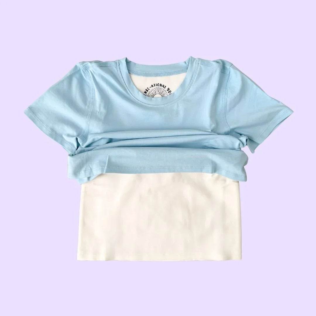 Light blue compression sensory shirt with white sensory panel on pastel background
