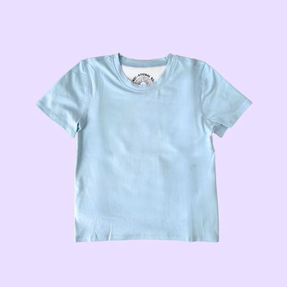 Light blue kids compression sensory shirt with short sleeves on a purple background