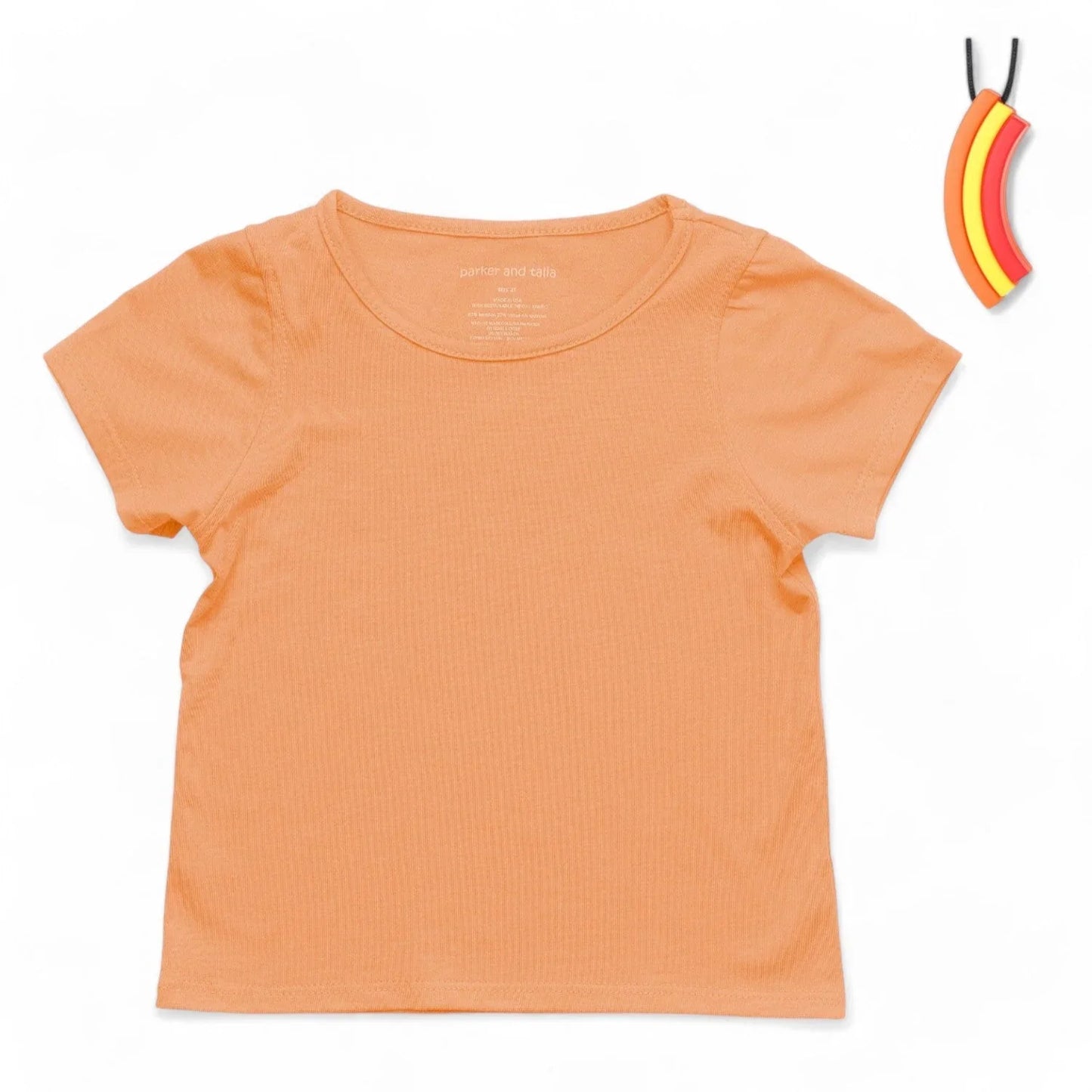 Coral short sleeve sensory-friendly kids' shirt with banana chewable necklace on white background
