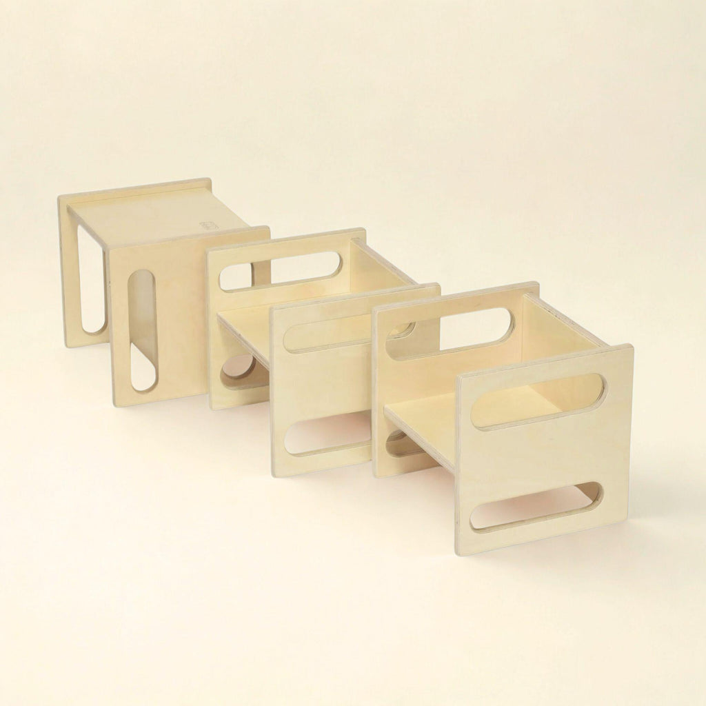 Set of three wooden stools on a beige background