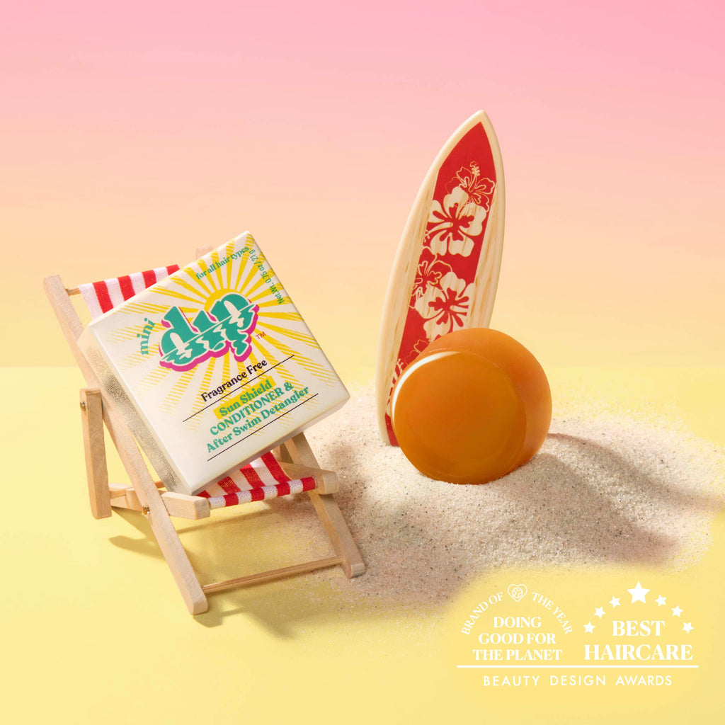 Bar of soap on a beach with a surfboard and deck chair, featuring a brand logo.