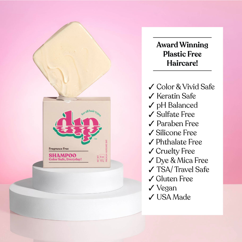 Shampoo bottle with a bar of soap on top against a pink background, featuring 'dip' brand.