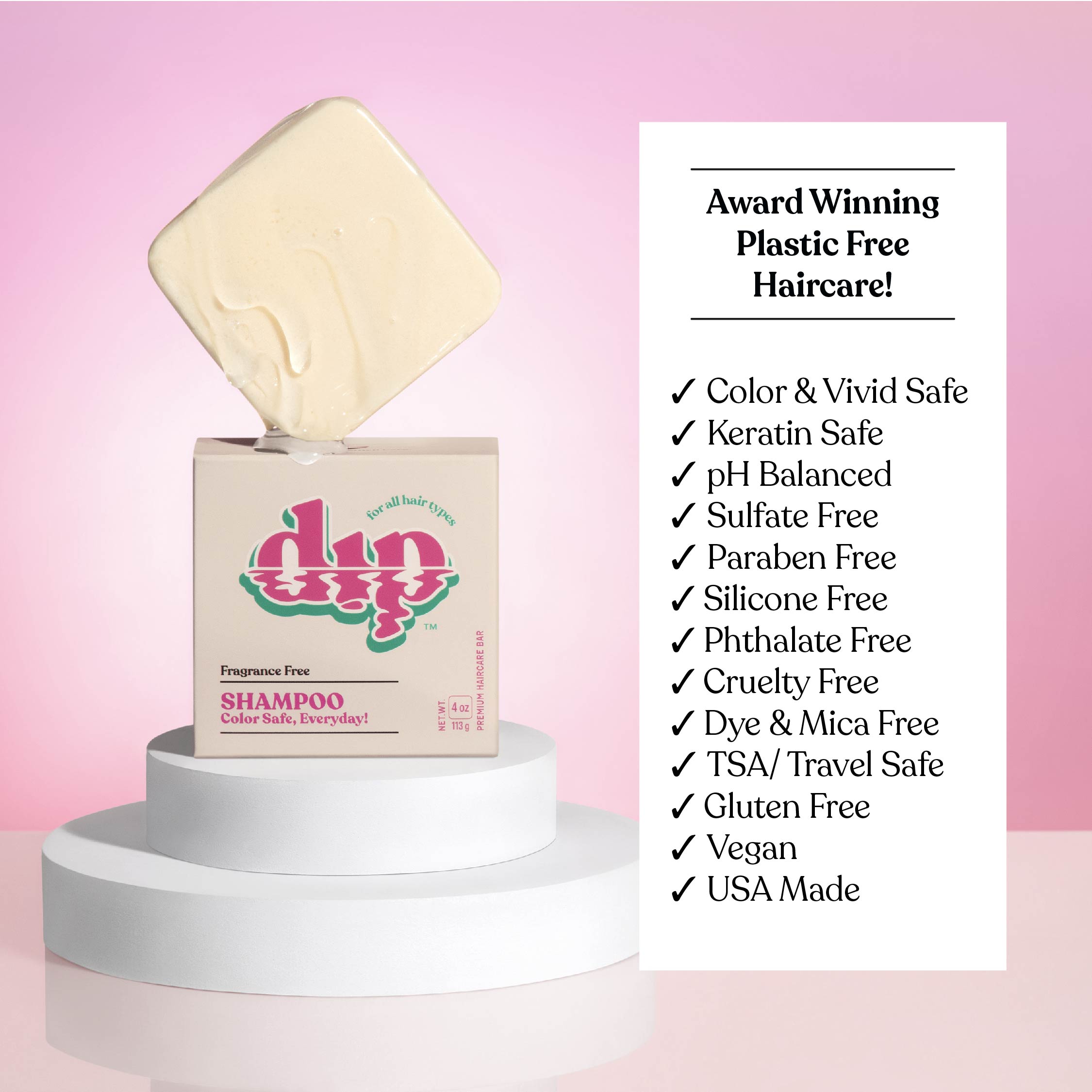 Shampoo bottle with a bar of soap on top against a pink background, featuring 'dip' brand.