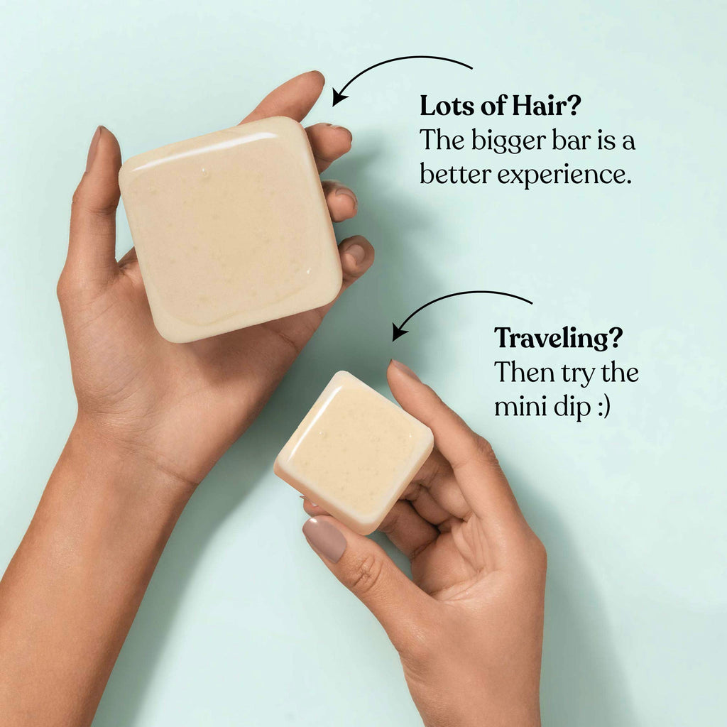 Two hands holding soap bars with text indicating different sizes for hair care and travel.