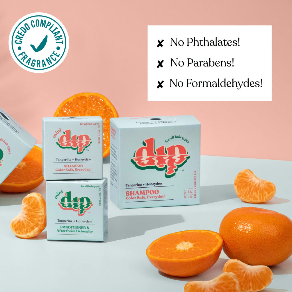 Dip shampoo boxes with oranges on a light background, featuring greenery compliance logo and safety claims.