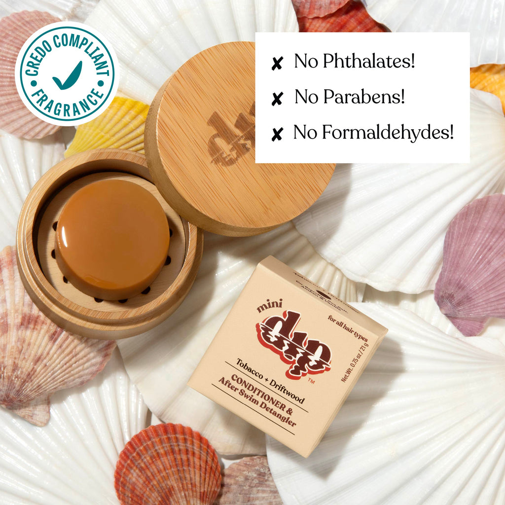 Cosmetic product with wooden lid and packaging on seashells, featuring green label and text about product ingredients.