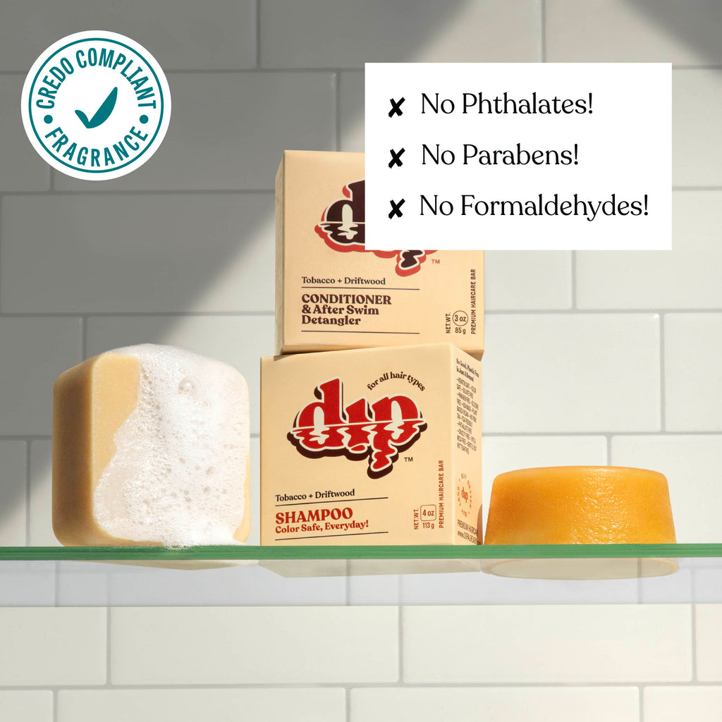 Shampoo bars and boxes on a shelf with green label and text about product ingredients.