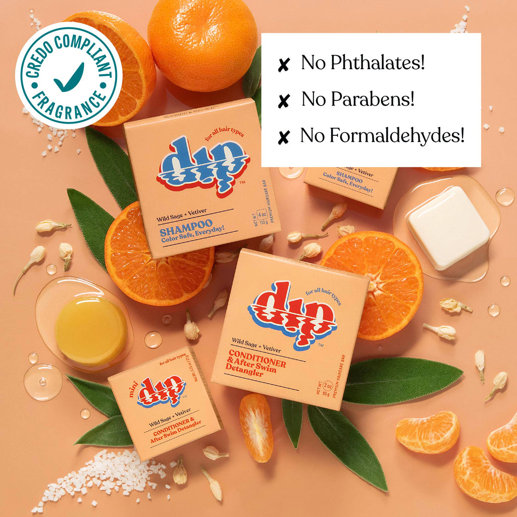 Dip shampoo and conditioner bars with oranges and leaves on a beige background