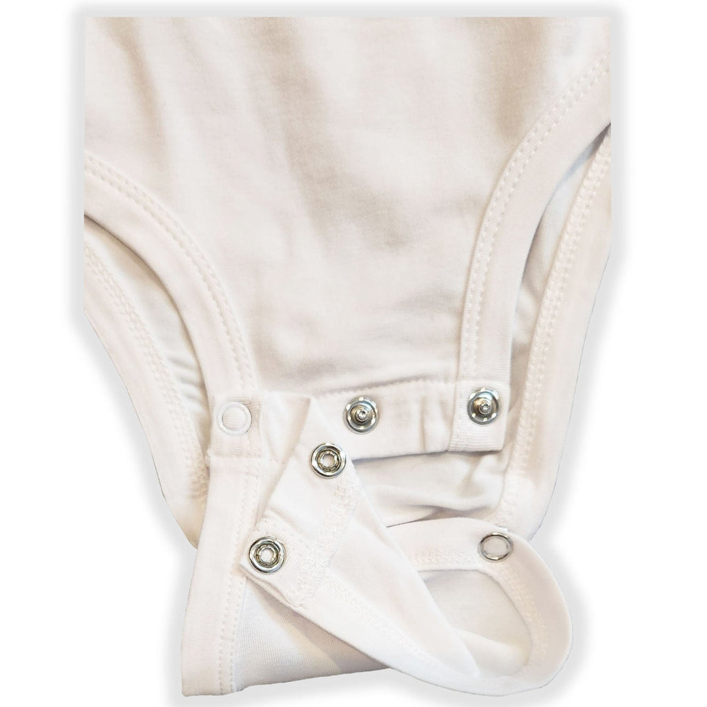 Close-up of a white baby romper with buttons on a light gray background