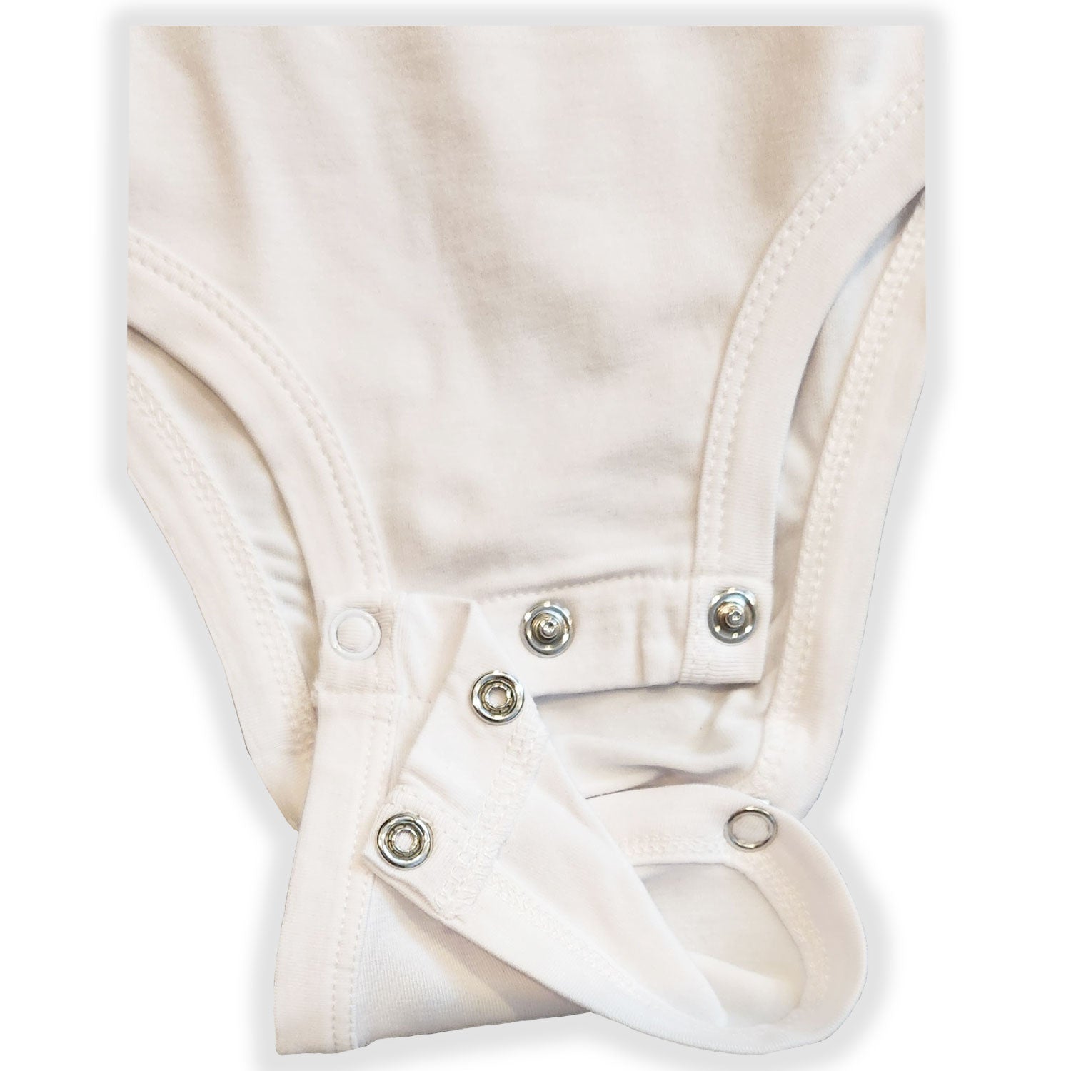 Close-up of a white baby romper with buttons on a light gray background