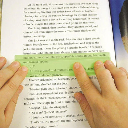 Hands using a green reading guide strip over a book page, aids focus and reading comprehension
