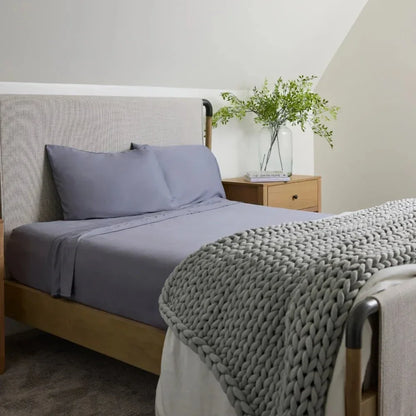 Arctic grey cooling weighted blanket on neatly made bed in modern bedroom
