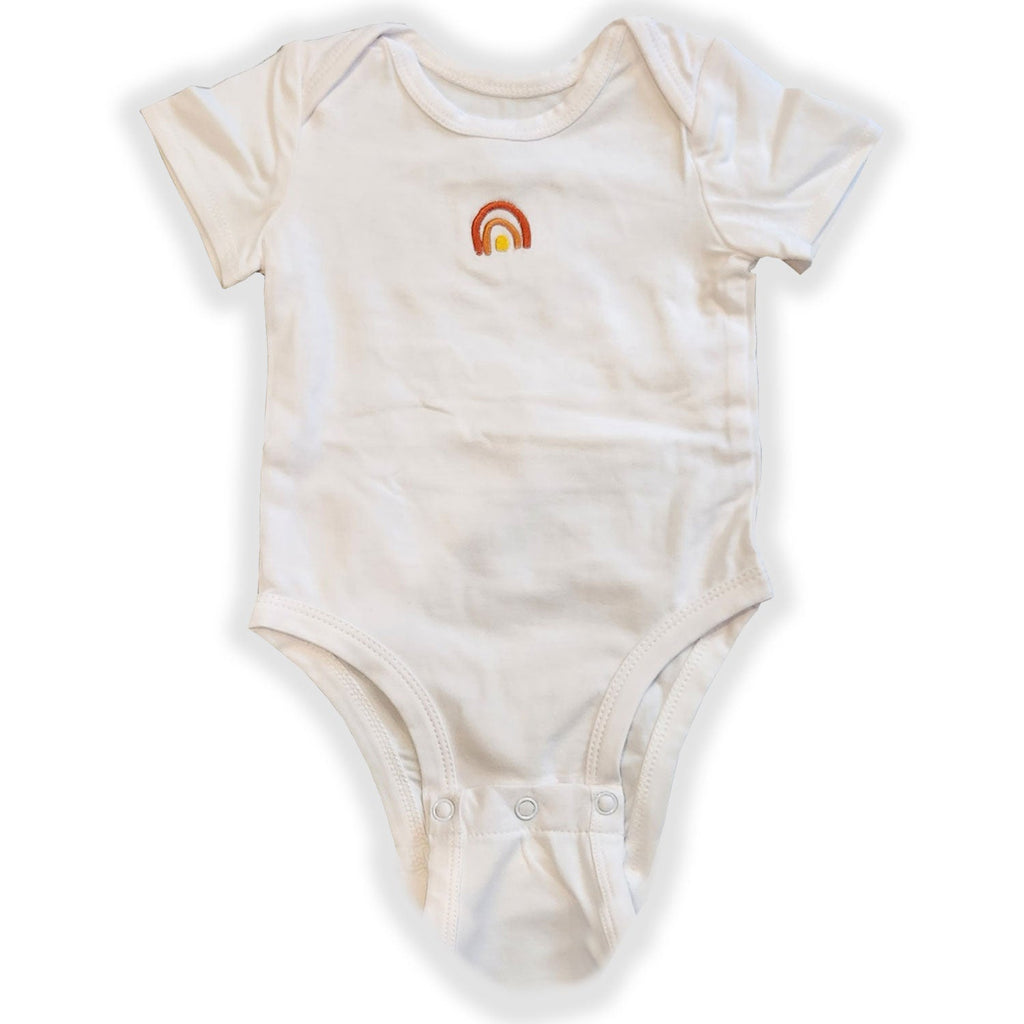 Beige baby onesie with a rainbow design on a white background