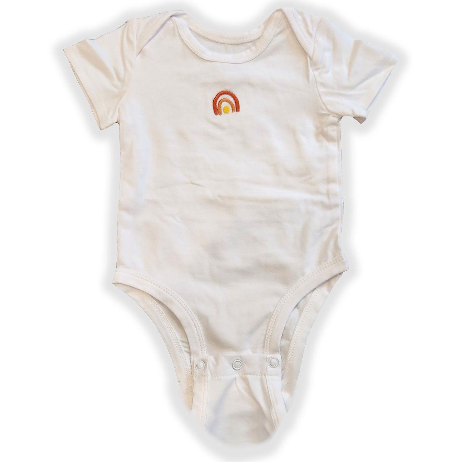 Beige baby onesie with a rainbow design on a white background