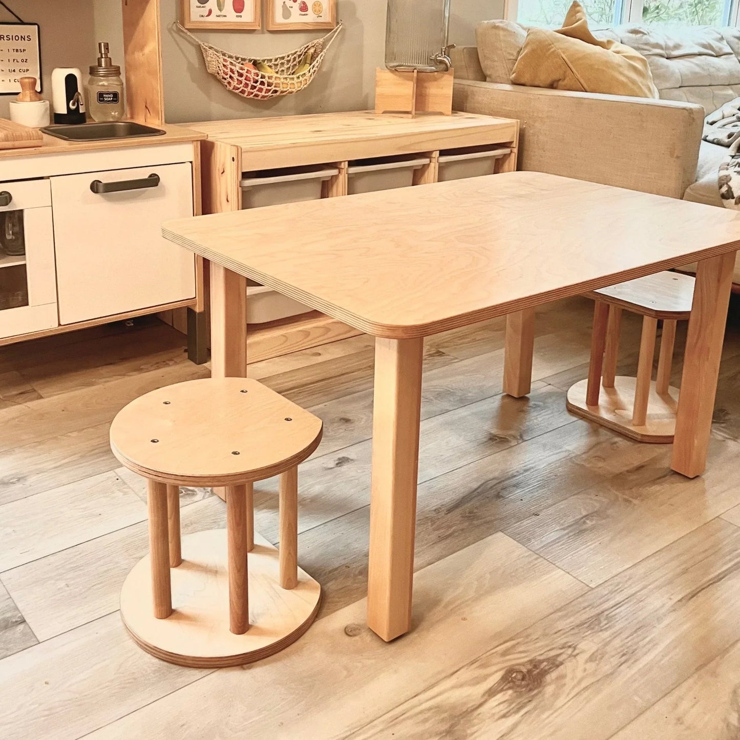 Wooden sensory-friendly kids table with two stools in cozy playroom setting
