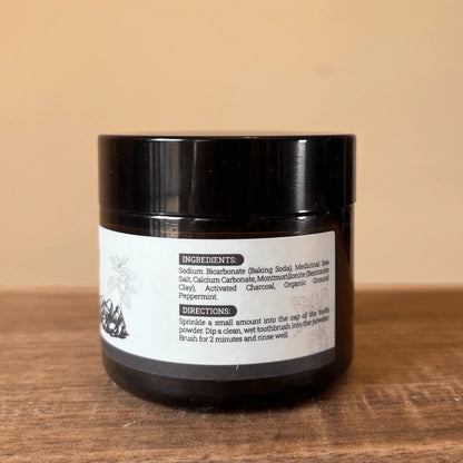 Natural fluoride-free herbal remineralizing tooth powder jar with ingredient label